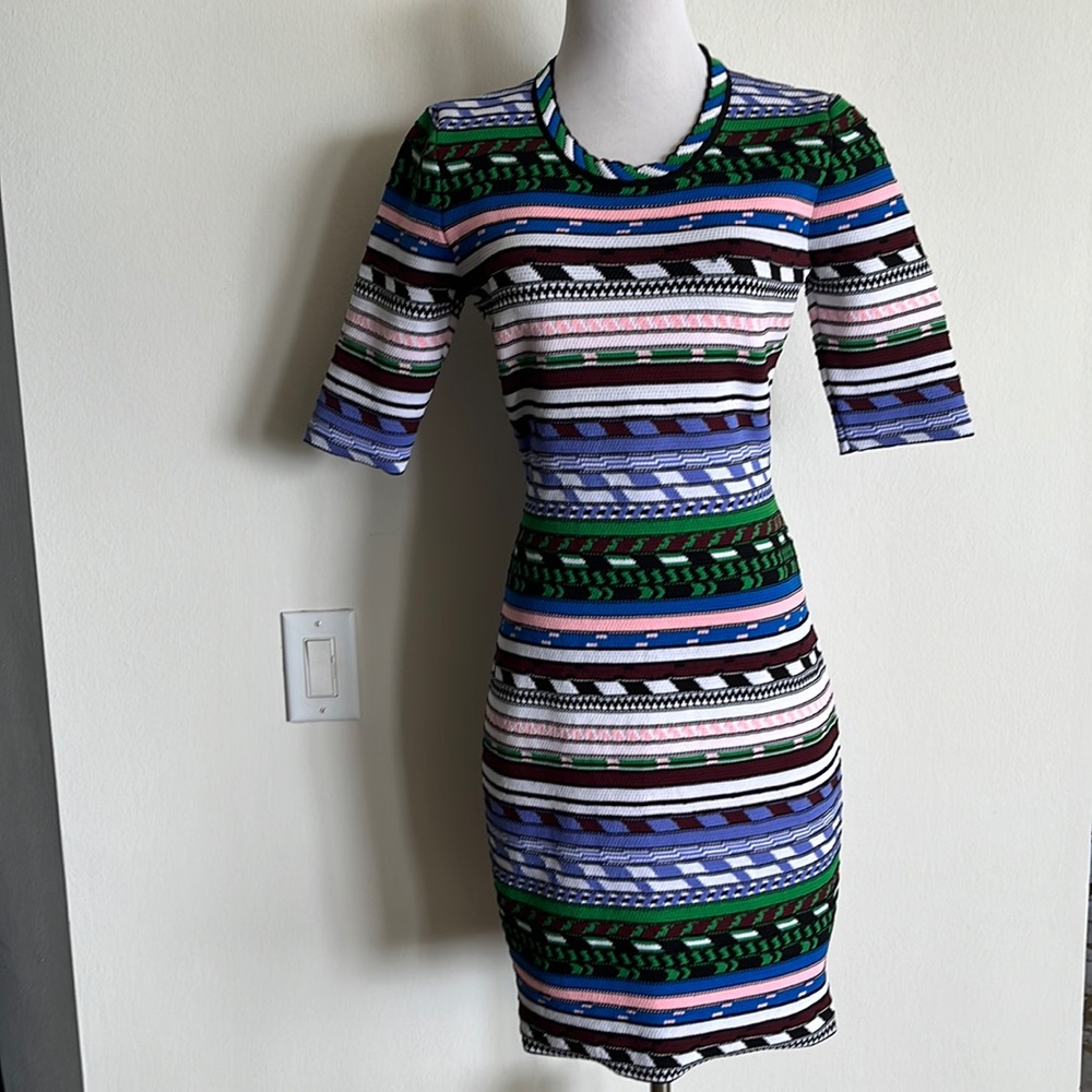 Woman’s dress is Christopher kane size large pink blue green